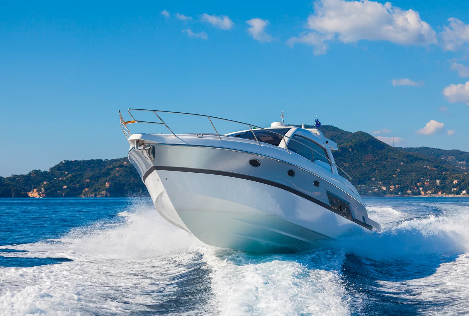 Motor yacht cruising at speed on open water