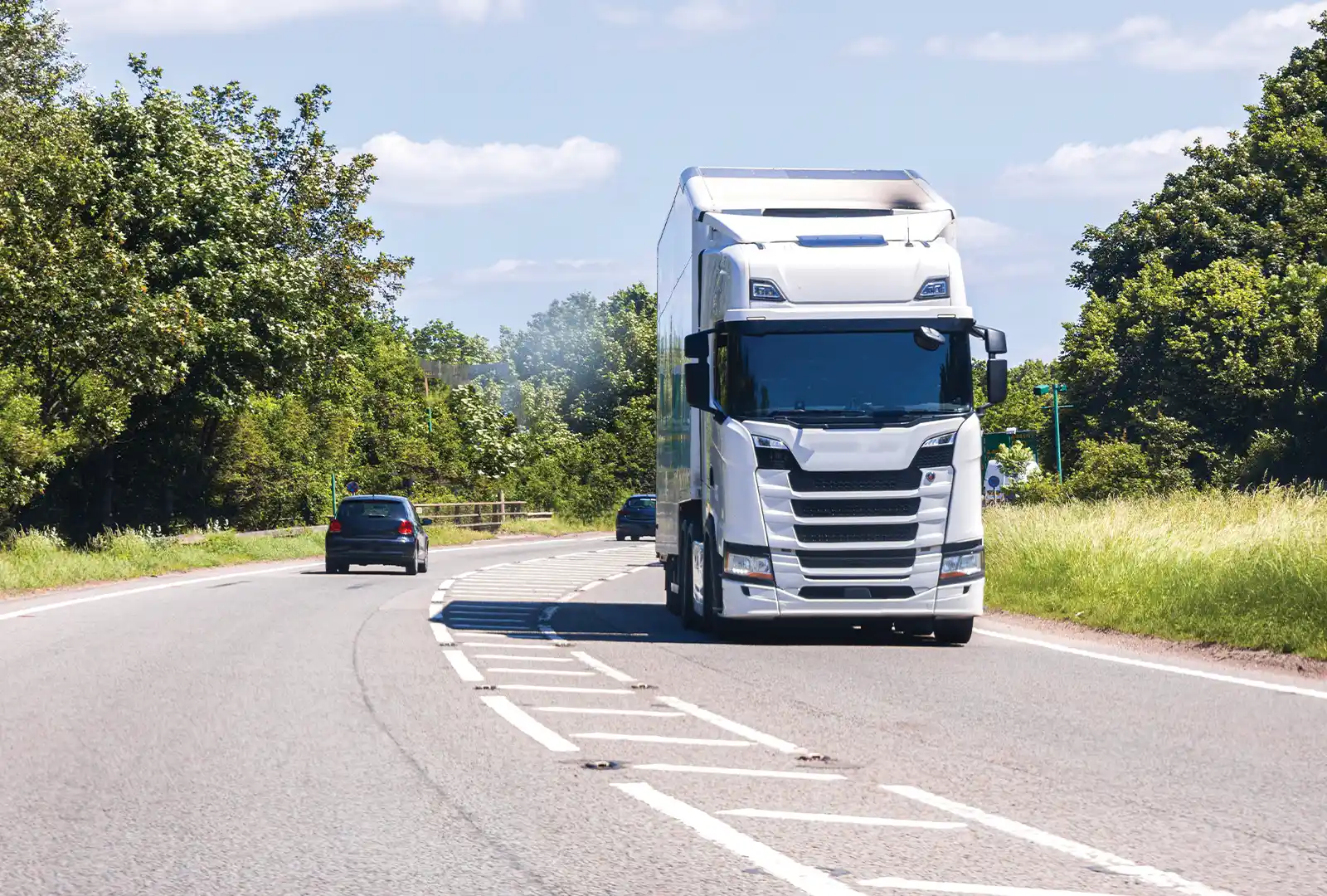 White articulated lorry on a country road