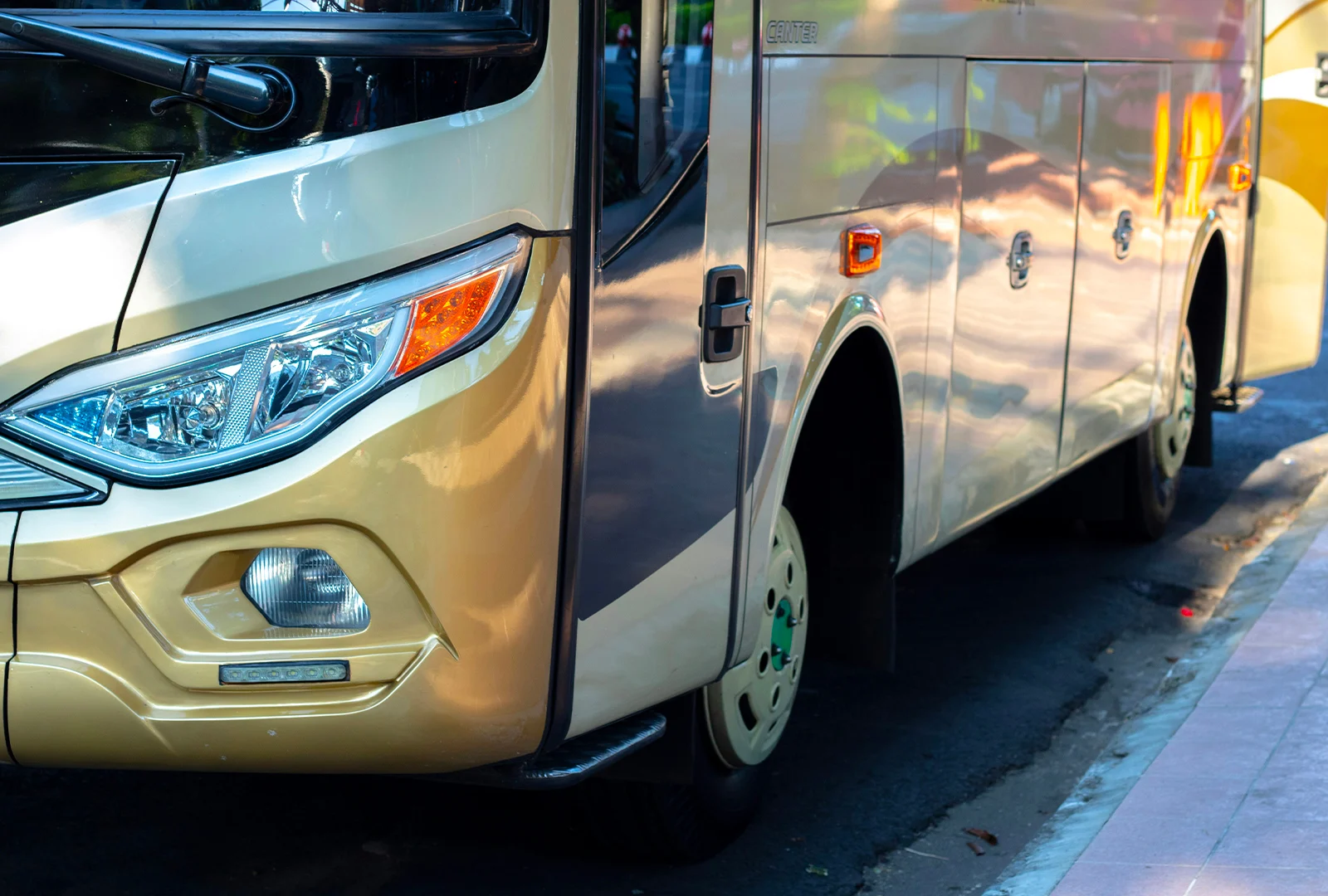 Front of a cream and gold touring coach