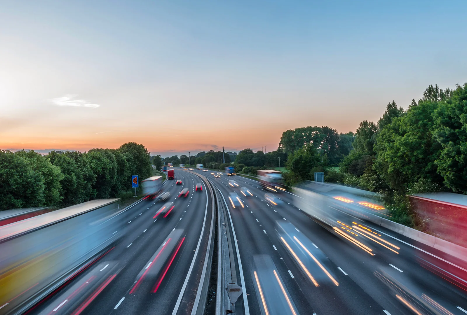 Motorway traffic at dusk with light trails