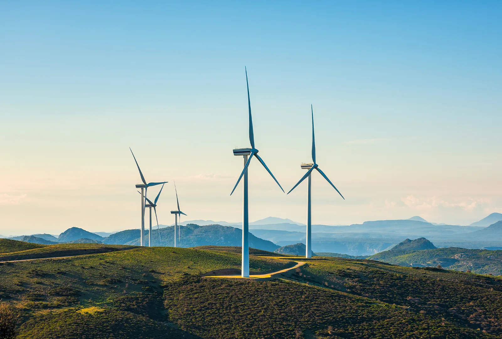 Wind turbines on a green hilltop