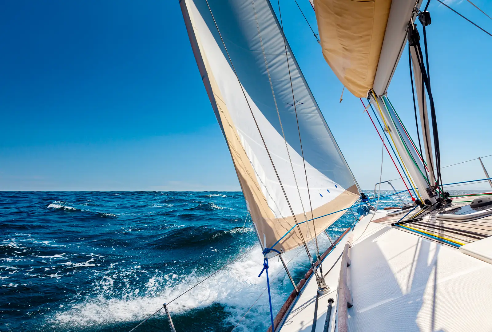 Sailing yacht heeling over in bright blue open water