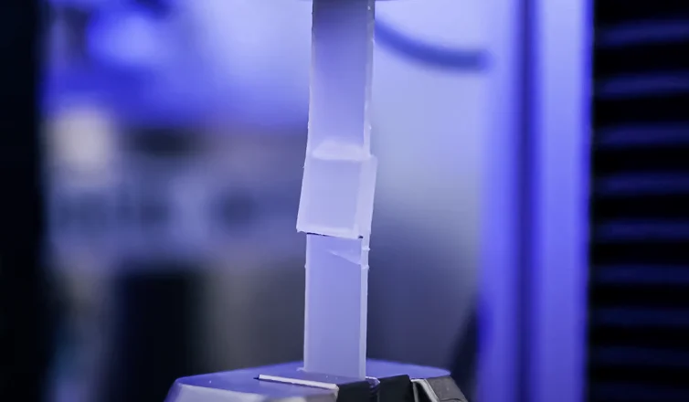 Clear plastic component under blue laboratory lighting