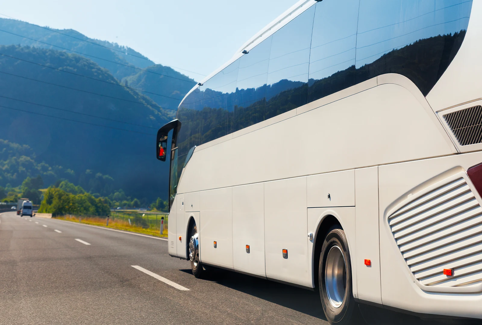 White coach on a mountain road